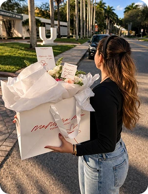 Woman holding a large bouquet of flowers from Mamma Mia Flowers