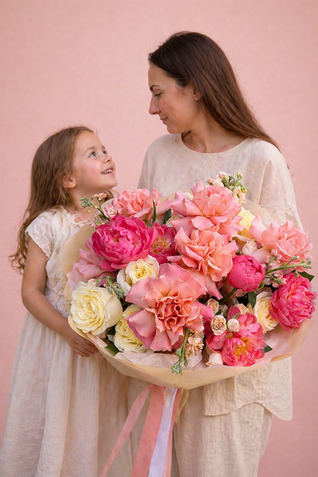 large bouquet of pink and yellow roses and pink peonies