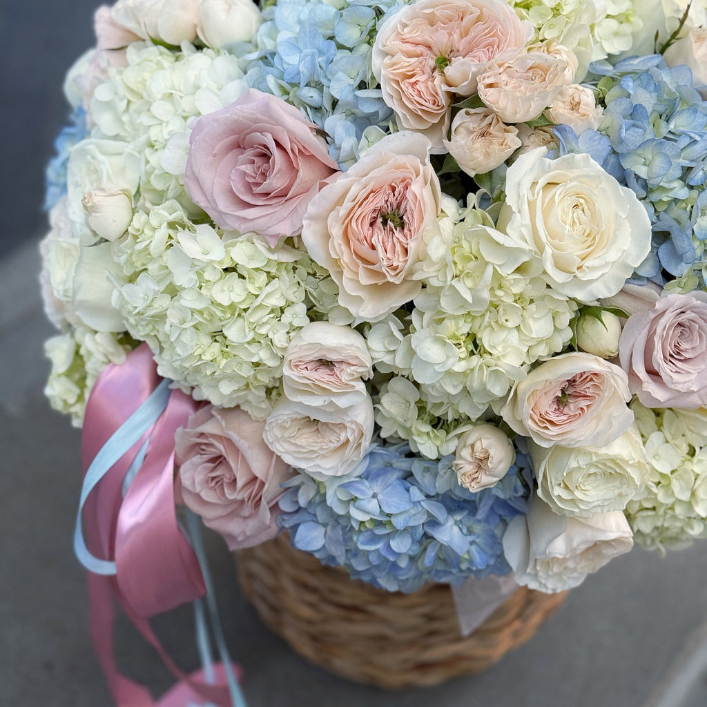 Luxury flower basket with blue hydrangeas and pastel garden roses