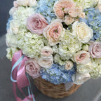 Luxury flower basket with blue hydrangeas and pastel garden roses