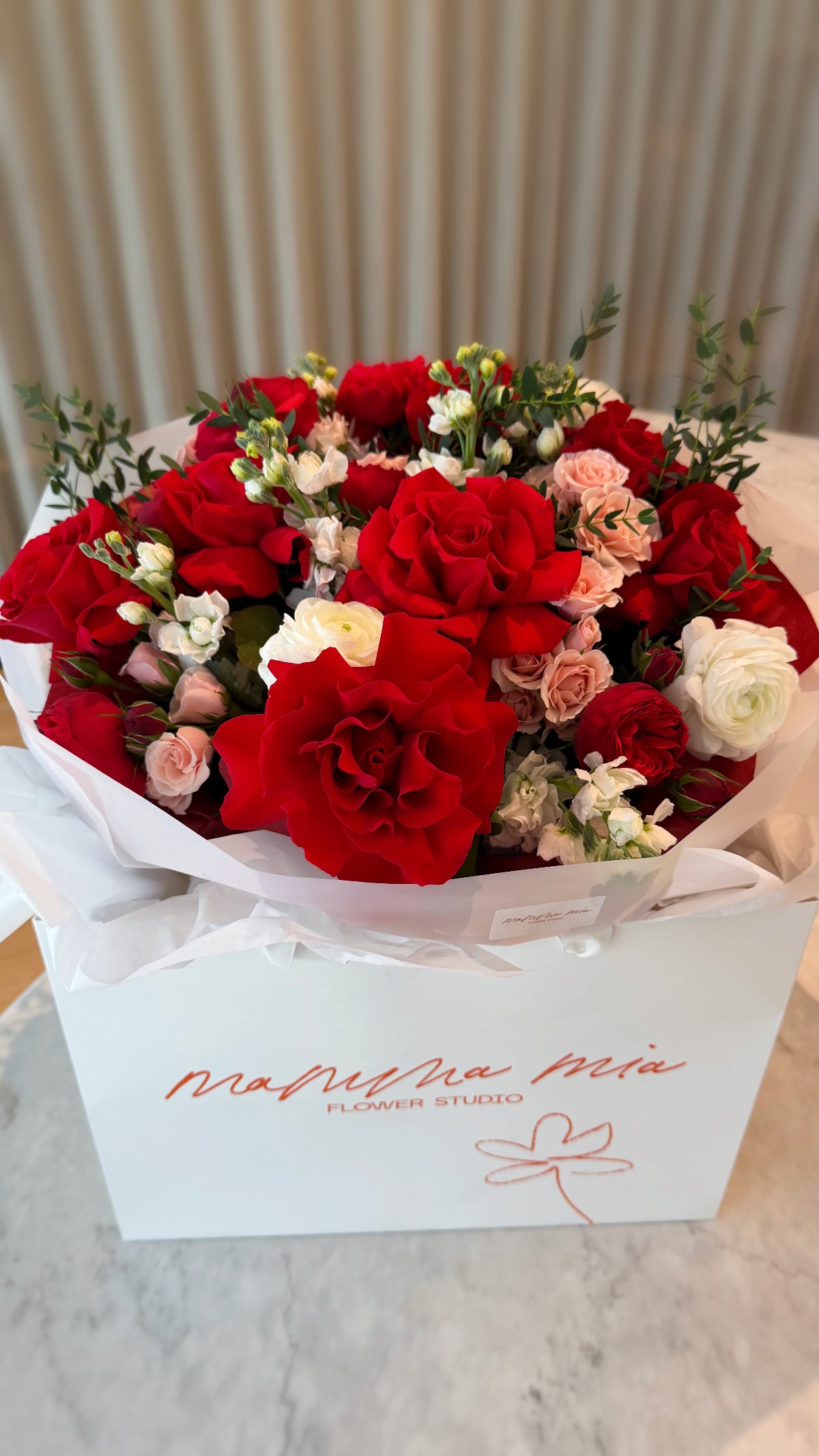 Luxury red roses bouquet with ranunculus and spray roses in Miami