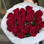 Close-up of luxury red roses bouquet wrapped in white paper