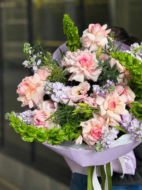 Luxury pink French roses bouquet with seasonal flowers in Miami