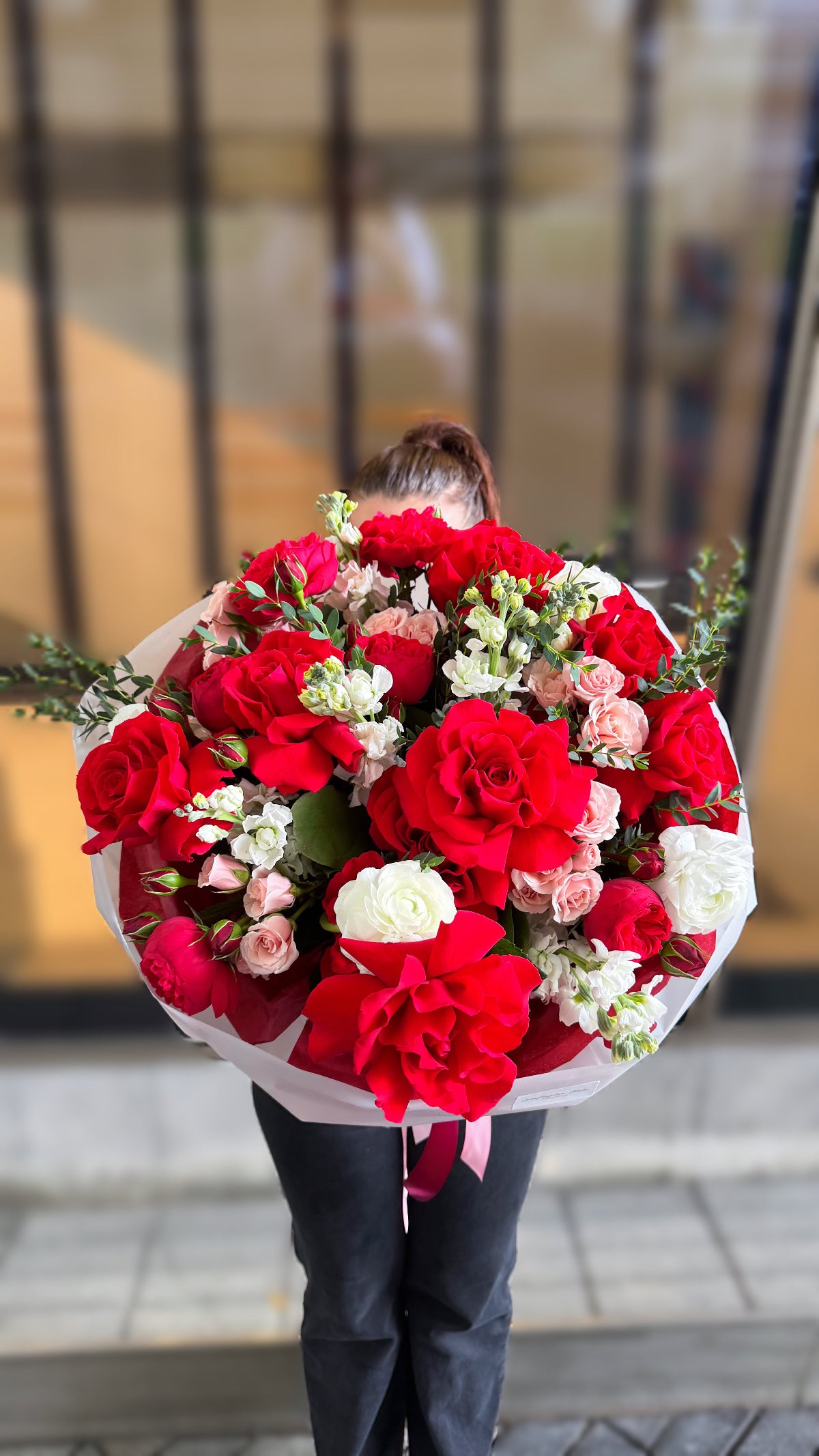 Red French roses and ranunculus bouquet with eucalyptus for flower delivery in Miami